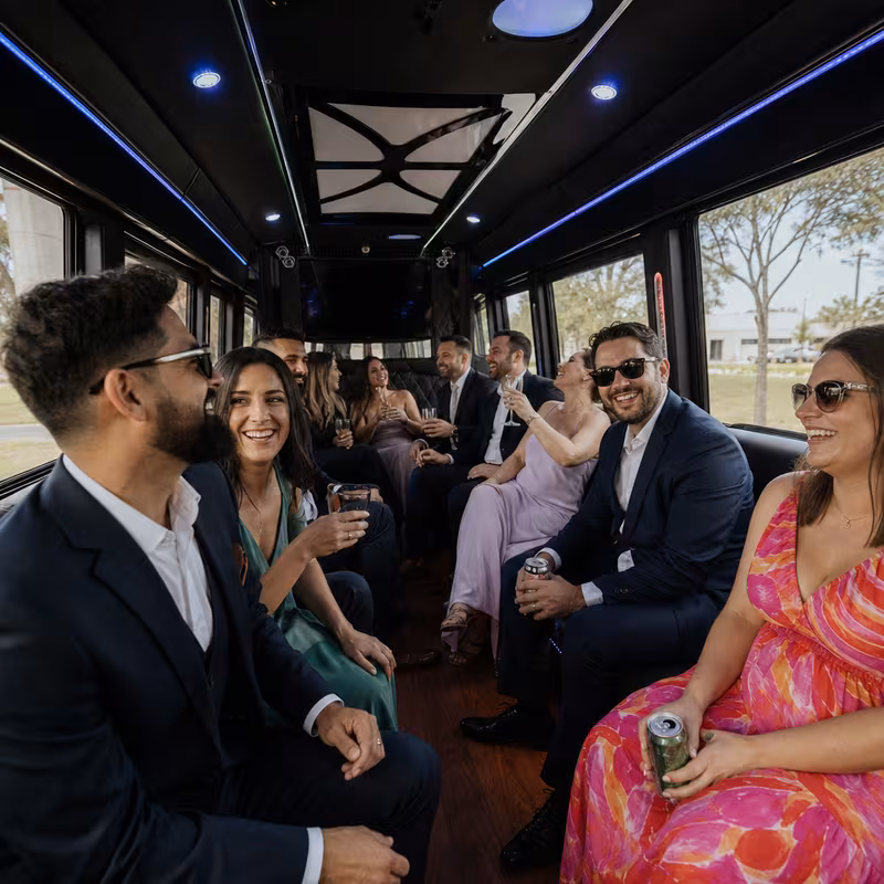 Wedding guests seated inside a Coral Springs party bus