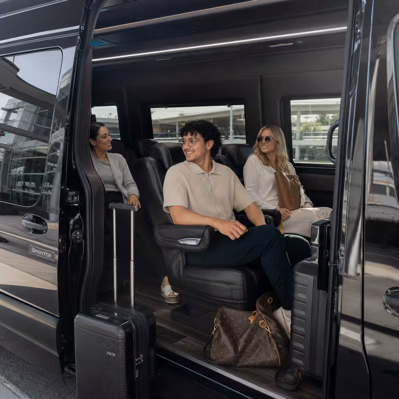 Passengers loading luggage while boarding an Coral Springs group shuttle