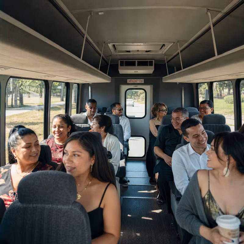 Group boarding a white charter bus for Private Event Transportation transportation in Coral Springs