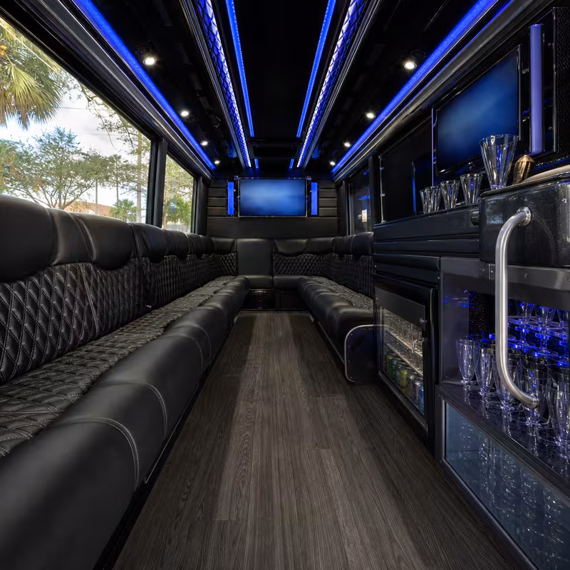 Party bus interior with wraparound leather seating and LED lighting in Coral Springs