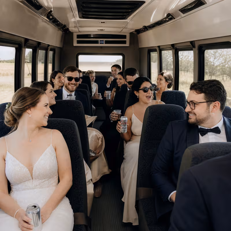 Group boarding a white charter bus for Wedding Transportation transportation in Coral Springs