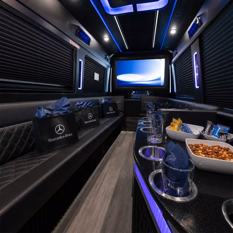 Party bus interior with wraparound leather seating and LED lighting in Coral Springs